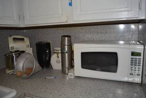 lot 11 image: Contents on Counter Rival Microwave, Stainless Steel Thermos, Pillsbury Mixer and More