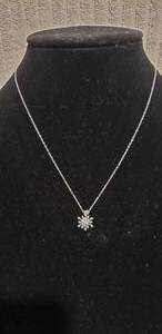 lot 563 image: Sterling Silver 18L chain with sterling rhinestone snowflake pendant. Both marked 925