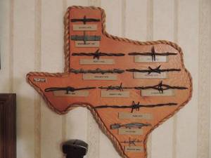 lot 52 image: Texas shape plaque with BARB WIRE  THRU THE YEARS 14x15 , GIFT WRAP AND VINTAGE FENCING PLIERS