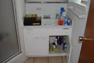lot 154 image: Contents of Bathroom Cologne, Hair Dryer, Shaver, Cleaning Supplies and Towels