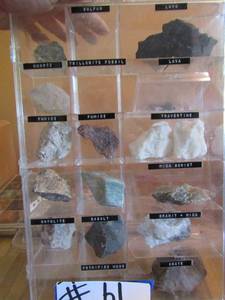 lot 61 image: Clear case full of rocks including agate, Basalt, Mica, quartz, and more
