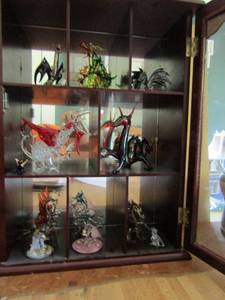 lot 91 image: Display case  of dragons (13) carnival glass apple, and more dragons