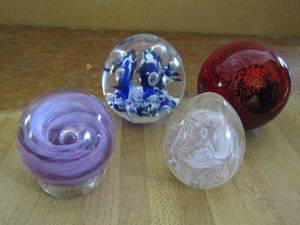 lot 110 image: 3D egg with pink ribbon design inside red glass ball moon and stars 3D purple Tweedmuir glass the Scottish borders blue flower 3d glass ball