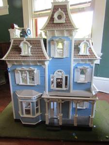 lot 123 image: 3 Story DOLL HOUSE  with turret on top over 20 windows and fire place. 34W x 19D x42H  Furniture included