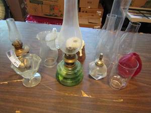 lot 476 image: 3 oil lamps assorted sizes with extra chimneys and  candle holders