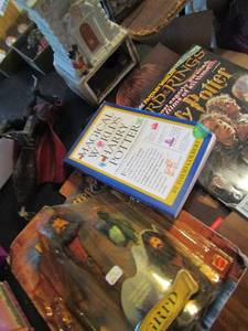 lot 544 image: Harry Potter lot- Gringotts ceramic house, harry on broom, Hagred in  box, bookends and magazines