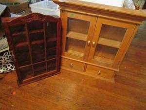 lot 600 image: Hanging cabinets x 2. dark wood and glass 20x13x2.5 light wood double doors 2 shelves 2 drawers 22x23x7