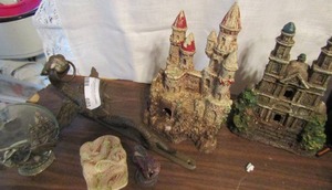 lot 603 image: Dragon lot- 2 castles, metal wall hanging, oil lamp  and more