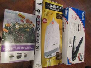 lot 673 image: Heavy duty stapler in box, 9 outlet surge protector in box, Aero garden mountain meadow series