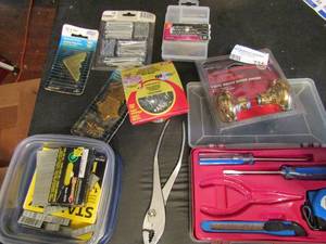lot 734 image: Home tools kit- staples, nails, hinges, door knobs plyers glassier points