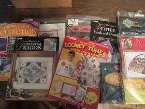 lot 738 image: Box of large volume of cross stich patterns loony tunes, holidays, and more over 40 packs