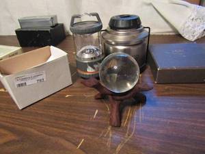 lot 793 image: Coleman lamp x 2    ugg sheepskin care kit    glass ball on wood tree stand