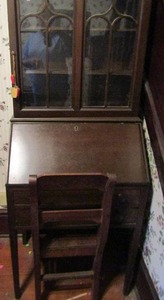 lot 976 image: Secretary desk 2 glass doors open to 3 shelves fold out to reveal desk and storage 2 drawers includes chair 63 tall 25w x 16 deep