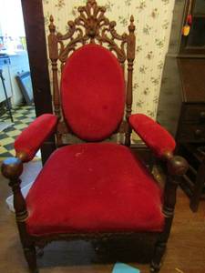 lot 4 image: Victorian Chair on wheels hand carved Walnut , Rose trim Red velvet upholstery  50 tall 25 wide 26 deep