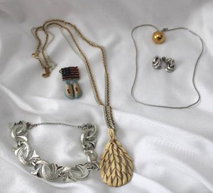 lot 504 image: Signed Coro bracelet and signed Monet jewelry. Includes a 1970s era enamel pendant necklace and a leather beaded moccasin flag pin