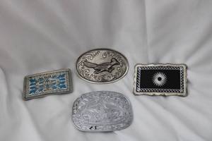 lot 517 image: (4) Laser cut belt buckles. Varying designs. No markings (Bid is times the money)