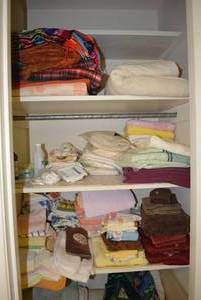 lot 347 image: Contents of Closet Towels and Blankets, Vanity Chair and Ceramic Trash Can