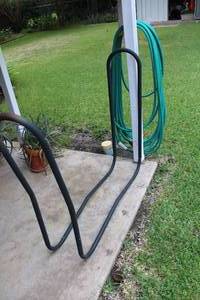 lot 394 image: Metal Firewood Rack and Garden Hose