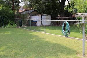 lot 392 image: Garden Hoses on Fence