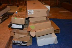 lot 438 image: Large lot of shipping boxes for guns many still have accessories in them and paperwork. MUST TAKE ENTIRE LOT ALL BOXES MUST GO