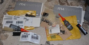 lot 40 image: Benelli M4 gun accessories and manuals 2 different models of gun accessories