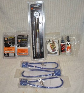 lot 701 image: Mixed Gun items Torch wrench gun cleaning oils, pull rope and locks  PREVIEW RECCOMMENDED
