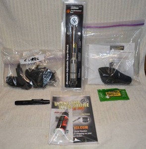 lot 702 image: Mixed Gun items Torch wrench gun cleaning oils, clip locks and sight cover  PREVIEW RECCOMMENDED