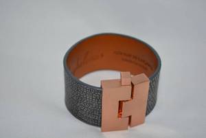 lot 716 image: Signed Leigh Elena Navarro (Austin, TX) exotic LIZARD wide jigsaw H cuff bracelet. Orig retail price $268 made in USA. Alloy buckle with pin clasp