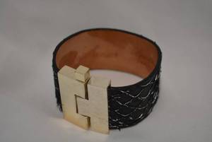 lot 717 image: Signed Leigh Elena Navarro (Austin, TX) exotic CARP wide jigsaw H cuff bracelet. Orig retail price $268 made in USA. Alloy buckle with pin clasp