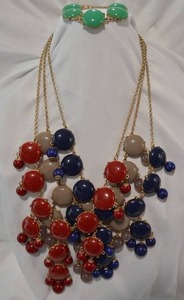 lot 725 image: Kendra Scott style necklace and bracelet group. Includes (3) 24L bib necklaces in black, merlot and olive and a green bracelet No markings All necklaces have a 3L extender.