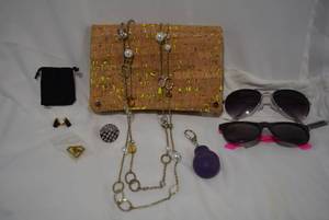 lot 728 image: Jewelry and miscellany selection. Includes a cork over yellow vinyl clutch, sunglasses, boxing glove keychain and more. Includes a single English shotgun shell black cartridge cuff link w storage pouch