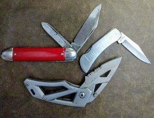 lot 135 image: Three pocket knives, Gerber , Things Remembered with a name Tom Babbitt, One has a red handle and USA on the bottom of the blade. (One Money)