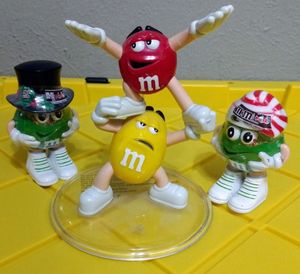 lot 208 image: Vintage M&M Figures Yellow & Red Plastic Candy Display 5.5 tall and two other M&M figures approximately 4 tall