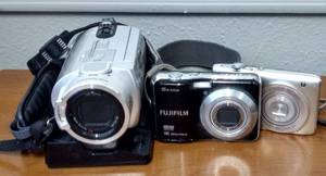 lot 222 image: Sony Handycam DCR-SR300 Video Camera, needs power cable, Fujifilm FinePix AX550 bring AA bateries to test, Nikon Coolpix S3100 14MP Digital Camera.