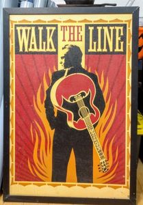 lot 246 image: Johnny Cash Walk the Line Wall Poster image is on hard board framed and 38 by 26