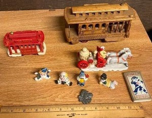 lot 156 image: Ceramic Horse drawn fire engine (one horse detached), model toy trolley in wood and one in plastic  several clown figurines&nbsp