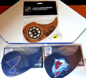 lot 128 image: COLLECTION OF NHL LICENSED GUITAR PICK GUARDS - BRUINS, BLUES, & AVALANCHE