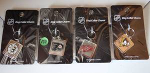 lot 159 image: ASSORTMENT OF NHL DOG COLLAR CHARMS - BRUINS, FLYERS, RED WINGS, & PENGUINS