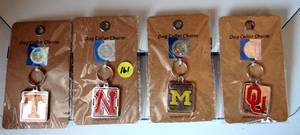 lot 161 image: ASSORTMENT OF NCAA DOG COLLAR CHARMS - TENNESSEE, NEBRASKA, MICHIGAN, & OKLAHOMA