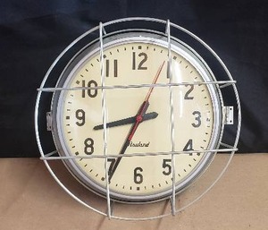 lot 63 image: Vintage Rauland Wall Clock - 12 Face with Cage, Metal Frame, and Glass Front