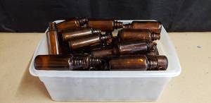 lot 85 image: Lot of 48 O.Berk Amber Glass Bottles