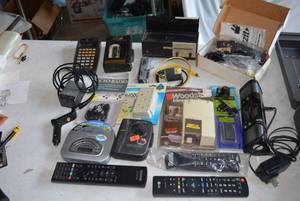 lot 166 image: Electronics Lot Remotes, Walkman, Micro-Radio, Surge Plug, Duzzit Handy Hanger