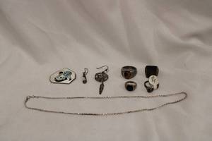 lot 388 image: Sterling Silver Jewelry Lot Includes Necklace marked 925 Italy, Ring with Tag reads JC Gen Sapp. SRSA08, Tigers Eye Ring and Enamel Pin