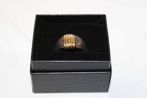 lot 408 image: 14K yellow gold and Sterling silver two tone wide ribbed ring. Marked 14K Sterling. Size 9. In box