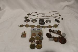 lot 420 image: Coin theme jewelry. Includes earrings, 2 bracelets, necklaces, button covers and more. One bracelet needs a jump ring.