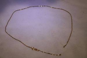 lot 433 image: 14K yellow gold tinsel necklace (needs repair). Marked 14K. 17L
