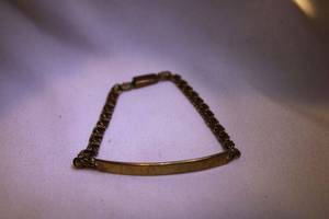 lot 438 image: 14K yellow gold childs ID bracelet (blank) with double cable chain bracelet. Marked 14K. Hidden box clasp but could not open.