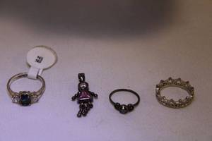 lot 445 image: (4) Sterling silver selection. Includes blue stone ring (size 6), figural star ring (unmarked, Size 4.5), vintage Spinel or Iolite ring (Size 2.5) and birthstone figure pendant (marked 925).