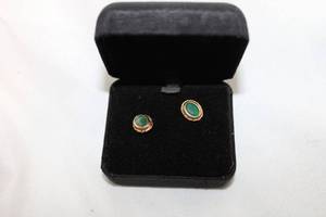 lot 458 image: 14K yellow gold faceted Emerald solitaire poststud earrings. Marked 14K RGE (RGE, Rare Gems of Earth trademark) on butterfly backs. Emeralds tested. Approx.50 carat each. Bezel set. In presentation box.