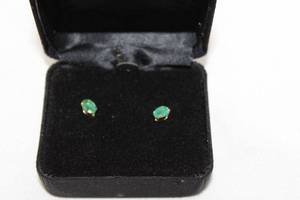 lot 463 image: 14K yellow gold Emerald solitaire poststud earrings. Marked 14K RGE (RGE, Rare Gems of Earth trademark) on butterfly backs. Emeralds tested. Approx.50 carat each. In presentation box.